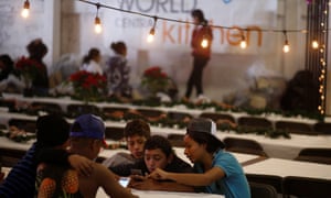 Migrants, part of a caravan of thousands from Central America trying to reach the United States, celebrate Christmas, at a temporary shelter in Tijuana, Mexico, on 24 December.