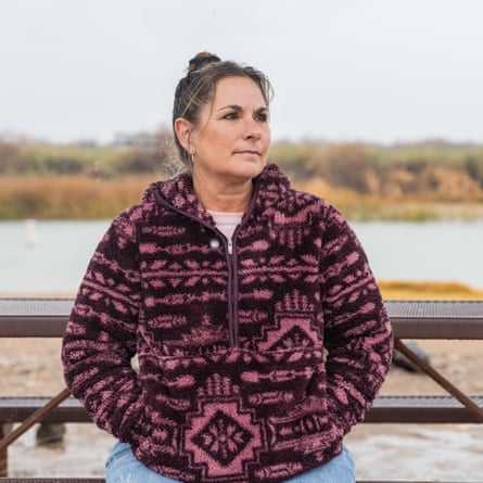 woman poses near river