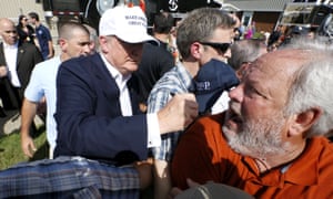 Donald Trump signs a supporter’s shirt outside Greenwell Springs Baptist church in Central, Louisiana.