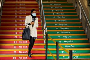 A commuter at Piccadilly railway station in Manchester. Workers are gradually returning to offices in the area after the easing of lockdown restrictions.