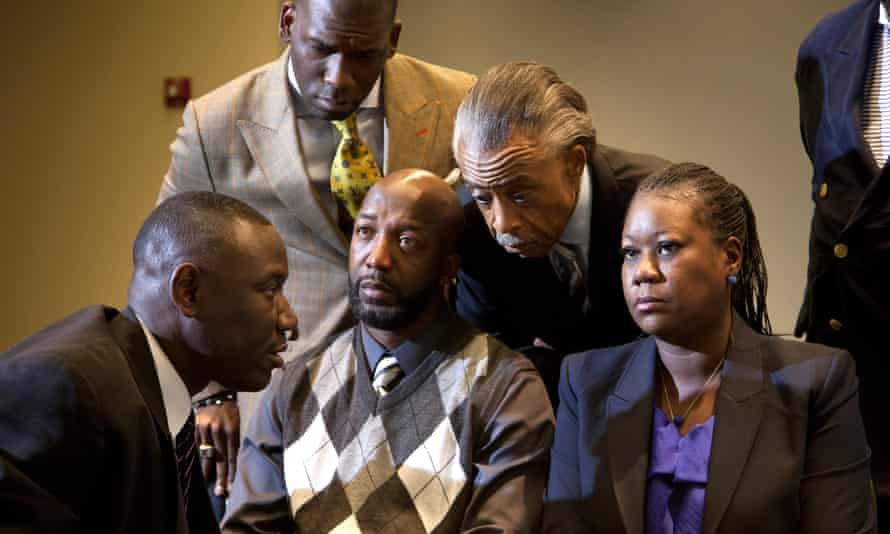 Sybrina Fulton and Tracy Martin, the parents of Trayvon Martin, talk to family lawyer Benjamin Crump and the Rev Al Sharpton on 11 April 2012.