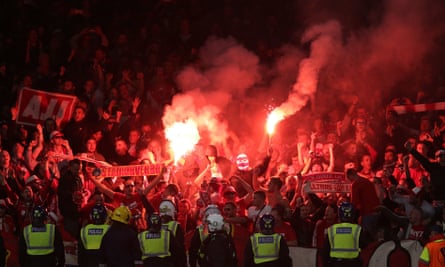 Flares are set off in the away end by Cologne fans.