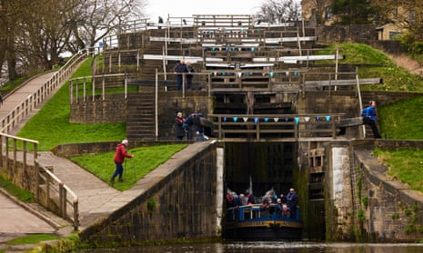 A canal boat passing through Bingley Five Rise locks in West Yorkshire