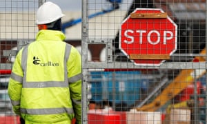 A worker walks into Carillions Midland Metropolitan hospital construction site after the company went into liquidation