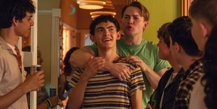 Two young men lightheartedly embrace each other