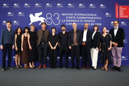 Rachel Szor, Yuval Abraham and producers and crew members stand in a row at a Venice film festival photocall