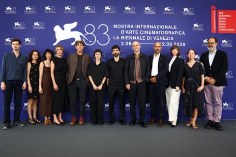Rachel Szor, Yuval Abraham and producers and crew members stand in a row at a Venice film festival photocall