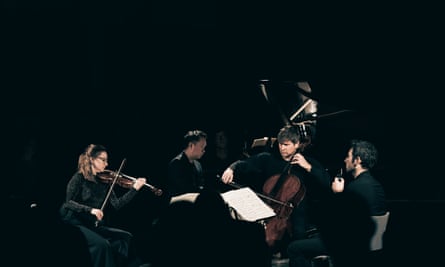 in a pool of light, Agata Daraskaite, James Cheung, Peteris Sokolovskis and Anthony Friend perform Messiaen’s Quartet for the End of Time at St John’s Waterloo