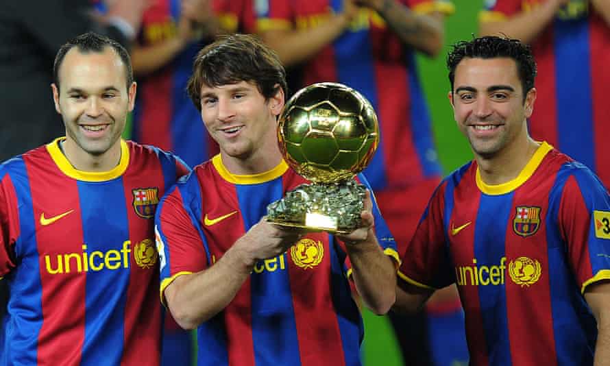 Lionel Messi with the Ballon d’Or in 2011, flanked by Barcelona teammates Xavi and Andrés Iniesta