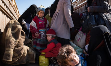 Women and children from suspected Isis families in the back of a truck