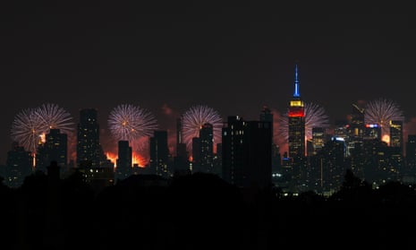 a row of buildings against of dark sky lit up by circles of sparkling light