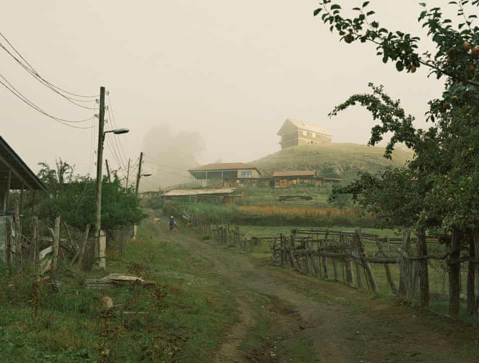 A man walking with his dog in the early morning in Lower Omalo