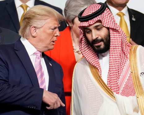 US President Donald Trump speaks with Saudi Arabia's Crown Prince Mohammed bin Salman during family photo session with other leaders and attendees at the G20 leaders summit in Osaka, Japan, 28 June 2019.