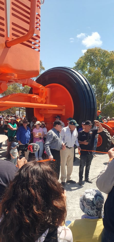 Bob Lukins and Hal Walton cut the ribbon to officially unveil the giant tractor sculpture in Carnamah