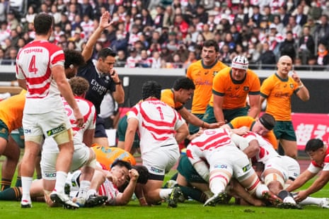 Referee Ben O'Keefe signals a try to Australia's Nick Champion de Crespigny
