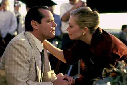 A woman leans in to a man with her hand on his shoulder at an outdoor event.
