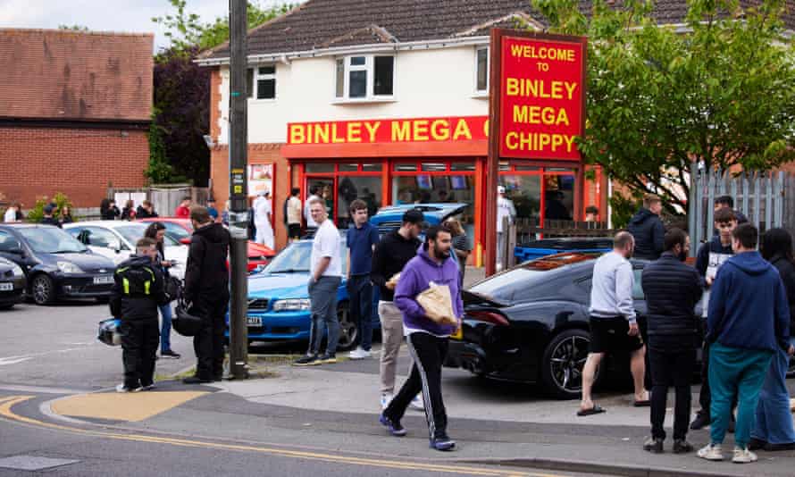 People gather outside Binley Mega Chippy in Coventry