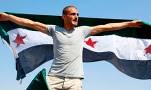 A Syrian man waves a flag of the opposition as he protests against the Assad regime and Russia in the rebel-held town of Maaret al-Numan in the north of Idlib province.