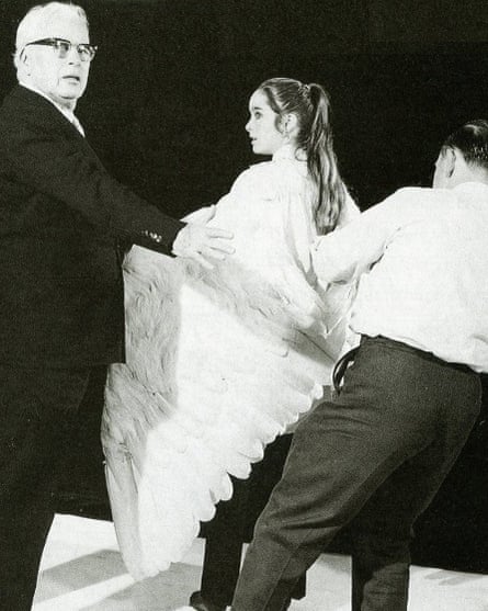 Two men work to attach white wings to Victoria