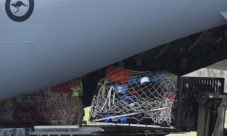 Australian aid supplies are unloaded from an aircraft
