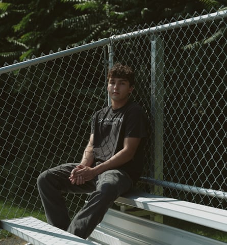 Brendan Dougherty, school friend of Gerson Turcios, sitting on a bench, leaning against a wire fence
