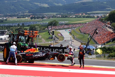 Max Verstappen looks on as his car is taken off the track