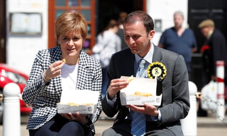 Nicola Sturgeon eats fish and chips with local candidate Stephen Gethins outside a fish bar in Anstruther, Scotland.