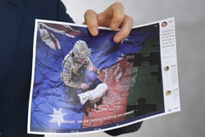 China rejects Australian PM's call to apologise for 'repugnant' tweet | Australia news 1 A journalist holds a copy of the image released by China’s foreign ministry showing an Australian soldier. This photograph has been pixellated by the Guardian.