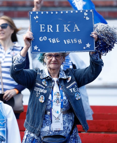 A North Melbourne fan holds a blue sign with the words, ‘Erika, go the Irish’