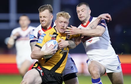 Castleford Tiger’s Zac Cini (centre) attempts to break through the Wakefield Trinity defence during the Super League match in April.