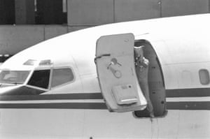 A gunman with a bag over his head fires an automatic rifle from a doorway of the hijacked Trans World Airlines plane at Beirut airport, Lebanon, 20 June, 1985. The gunmen lost patience with photographers perched on a balcony overlooking the plane. They opened fire. “They were annoyed by journalists taking pictures with big lenses,” recalled Frédéric Neema, one of the Reuters photographers on the balcony. “The bullets went above our heads and hit the wall behind us. I ducked and kept on shooting.”