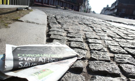 A discarded newspaper showing a government warning for people to stay at home