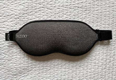 The best sleep masks in the us: i spent nine weeks testing 32 masks, and these are my favorites | sleep Grey and black eye mask on white quilt