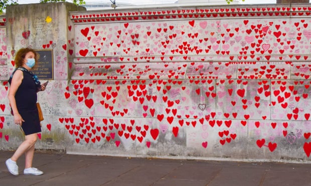 A woman walks past the National Covid Memorial Wall outside St Thomas’ Hospital in London.