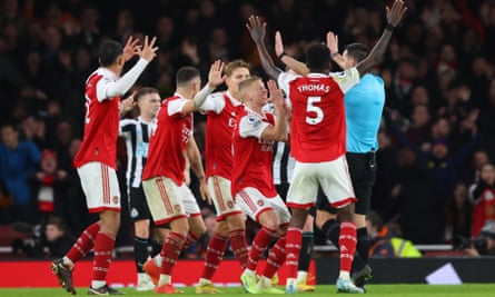 Arsenal players surround the referee Andy Madley appealing for a penalty against Newcastle