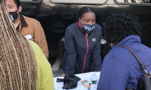 Juvanie Piquant, a volunteer with Strategy for Black Lives, helps register voters.