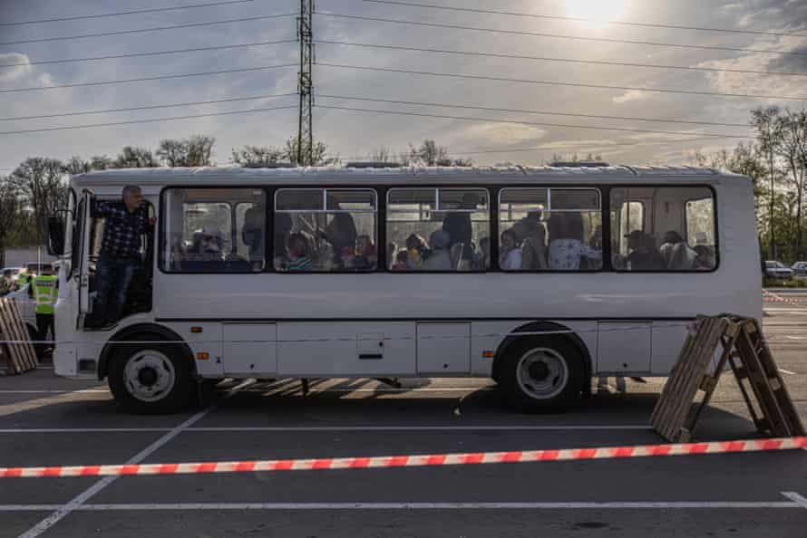 Evacuated people from the Russian-occupied Tokmak town arrive on a bus at the evacuation point in Zaporizhzhia, Ukraine, on Tuesday.