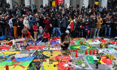 People gather at Place de la Bourse in Brussels to commemorate the attacks of 22 March 2016