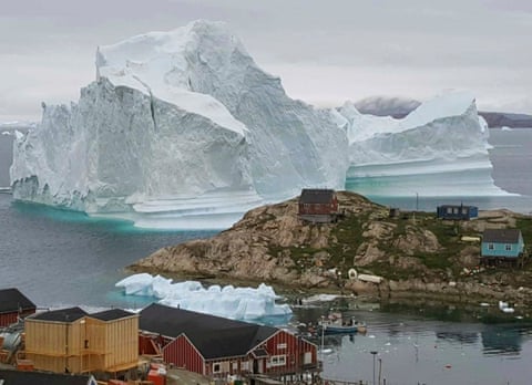 A 100m-tall iceberg threatens a village in Greenland.