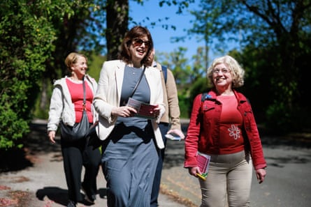 Three women walk down the street in the sunshine