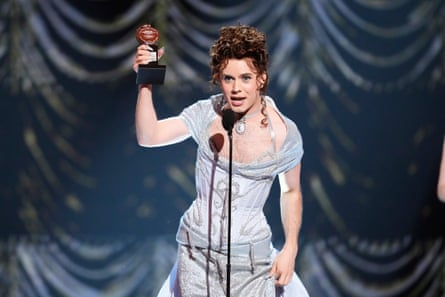 Cole Escola holds up the award while speaking into a microphone