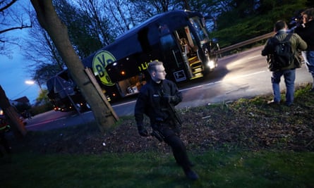 Police with the Borussia Dortmund team bus after an explosion near their hotel