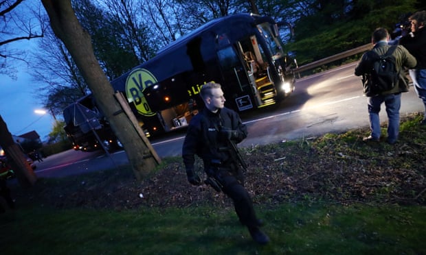 A police officer with the BVB team bus after the explosion on 11 April 2017.