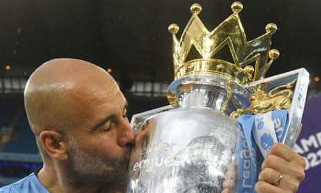 Manchester City's Spanish manager Pep Guardiola  kisses the Premier League trophy