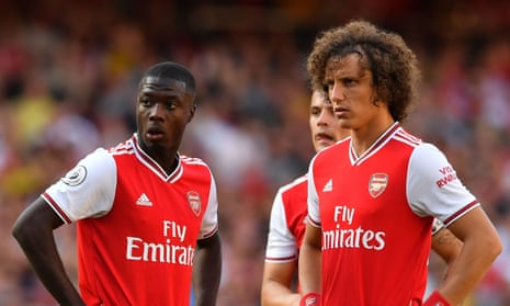The arrival of Nicolas Pépé (left) completes a mouthwatering front three for Arsenal, but having David Luiz (right) at the back is creating a new set of problems.