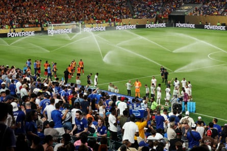 Players take a drink as sprinklers spray the pitch at Lincoln Financial Field