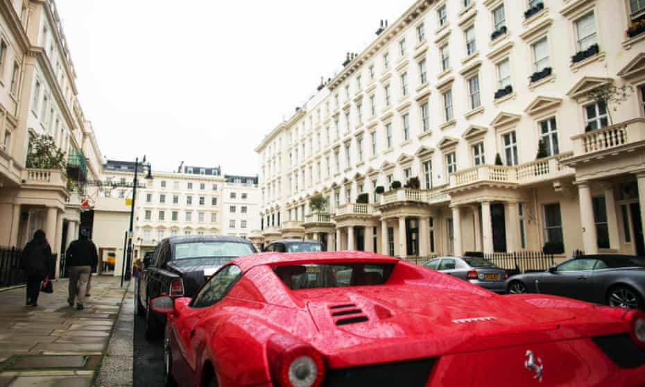 A Ferrari parked in a street in Kensington, where the average home costs £1.4m.