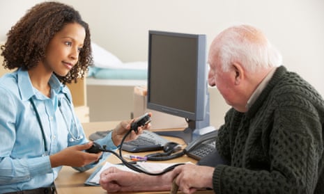 A GP takes a patient’s blood pressure