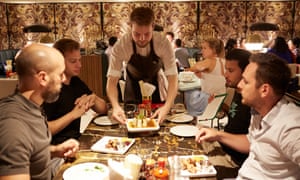 Diners served food at a restaurant in London
