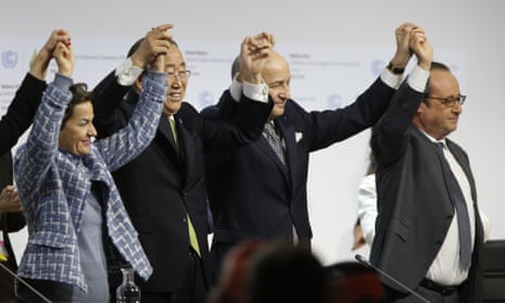 French foreign minister and president-designate of COP21 Laurent Fabius (centre), raises hands with UN secretary general Ban Ki Moon and French president François Hollande.
